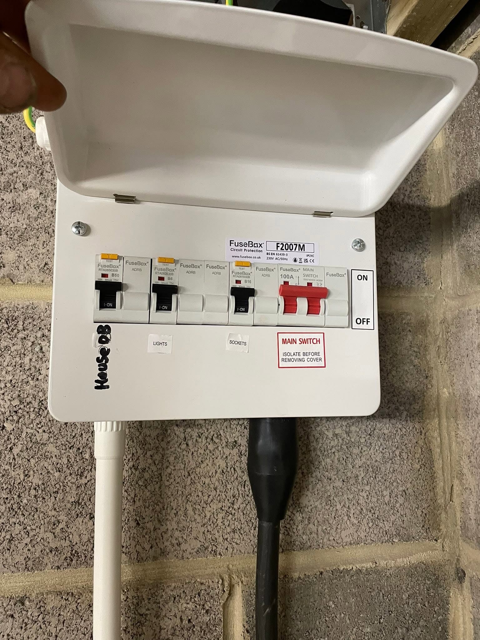 Compact garage consumer unit with a main switch, RCBOs and labelled circuits
