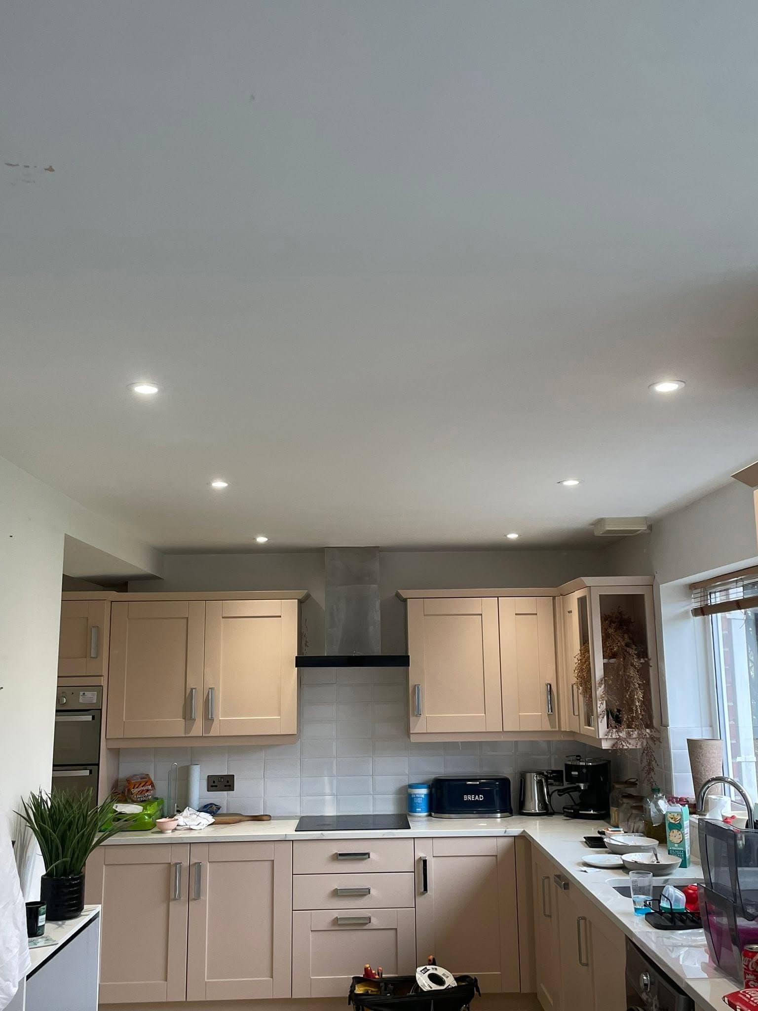 Kitchen ceiling with freshly installed recessed LED downlights above shaker units