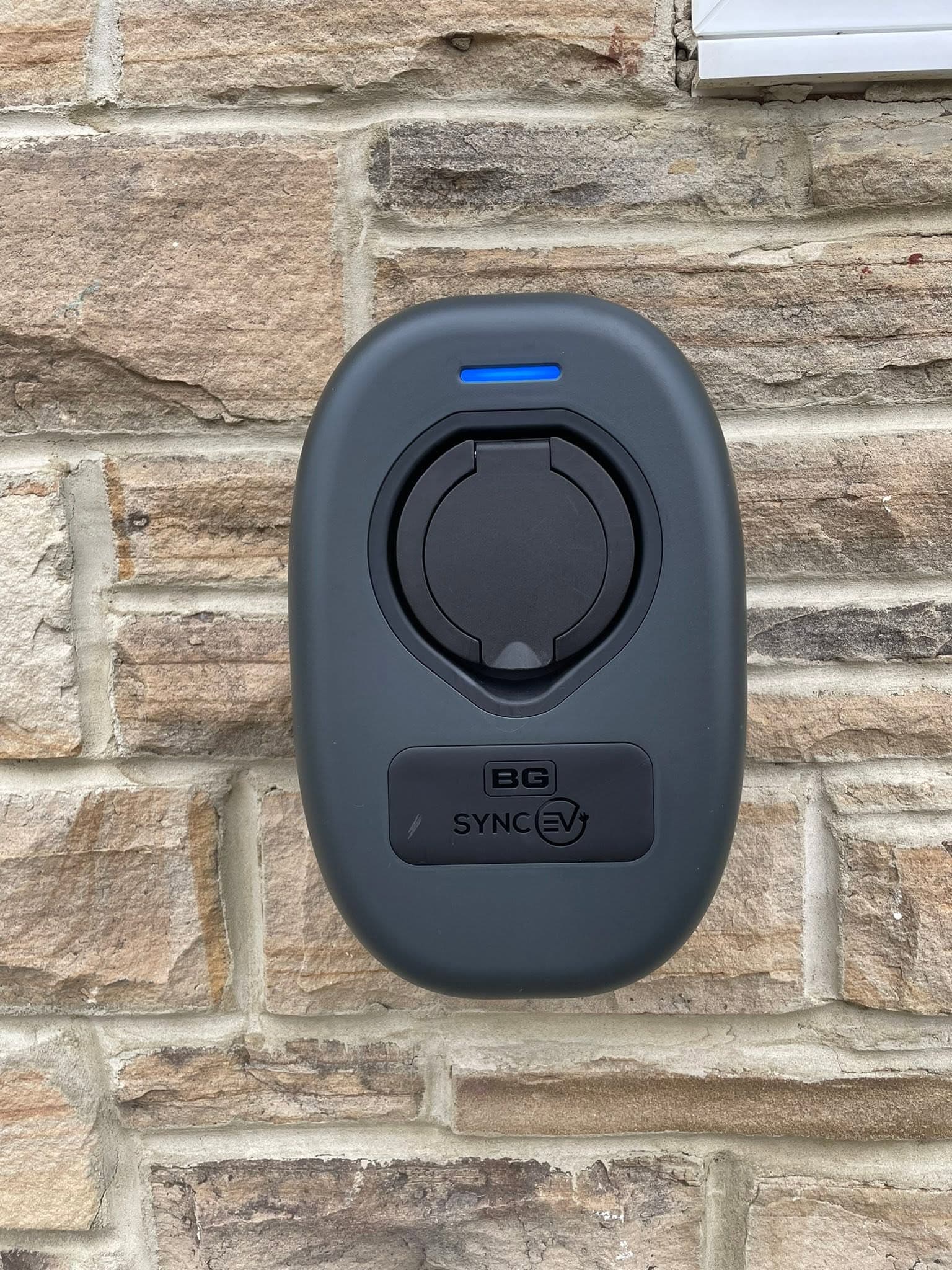 BG SyncEV home charge point mounted on a stone wall