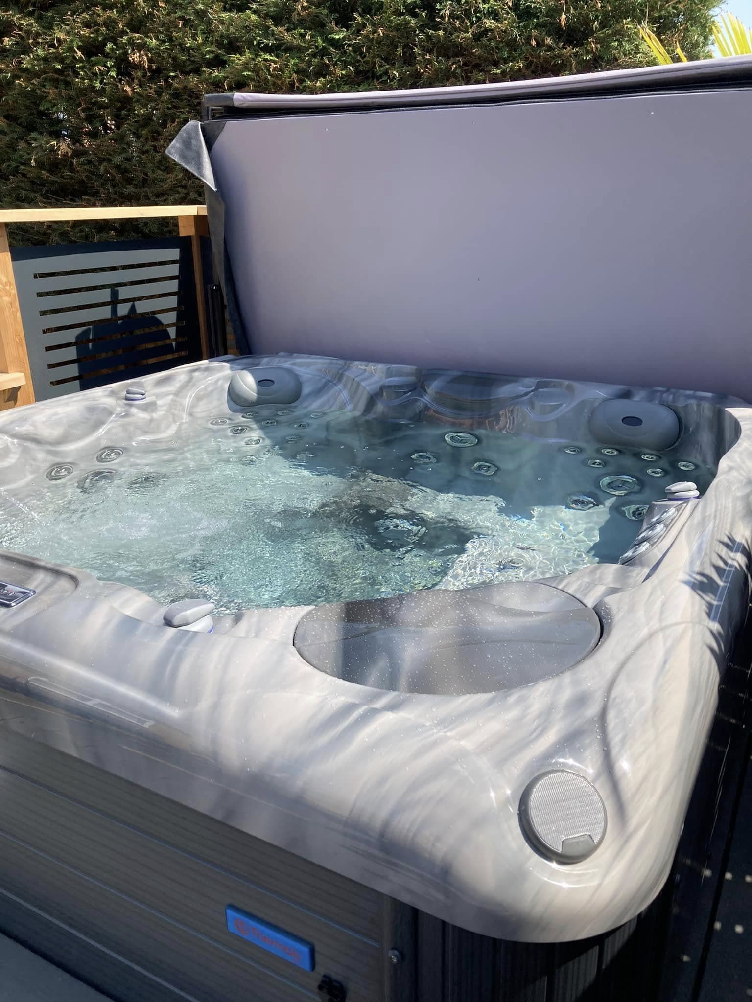 Hot tub with a dedicated outdoor power supply installed in a rear garden