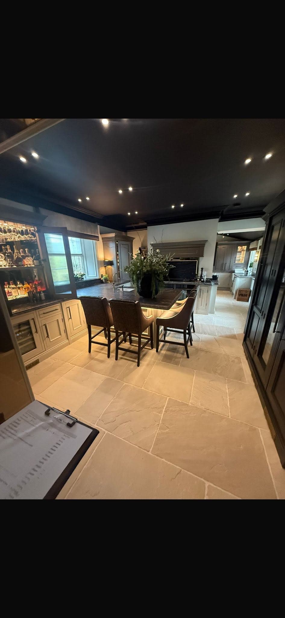 Premium kitchen and bar with feature downlights, under-island LED accent lighting and natural stone flooring