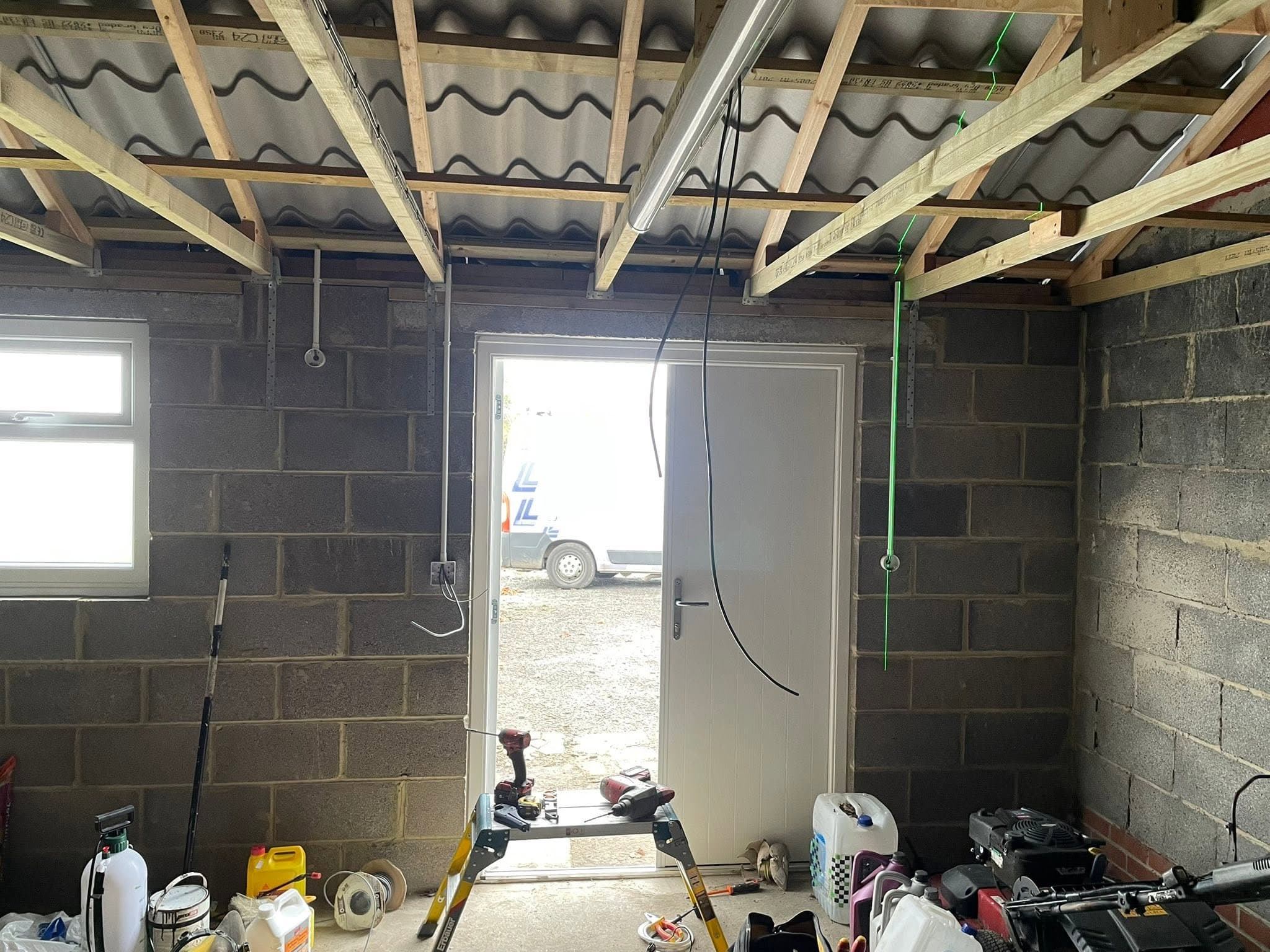 Garage conversion first-fix with surface conduit, sockets and a new external door fitted